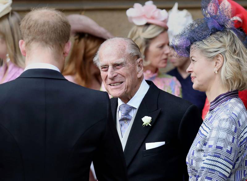Prince Philip, Duke of Edinburgh, chats to Prince Harry, Duke of Sussex, as they the chapel. AFP