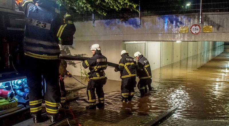 Firefighters pump water from a flooded underground car park in Sindelfingen.  Dettenmeyer / EPA
