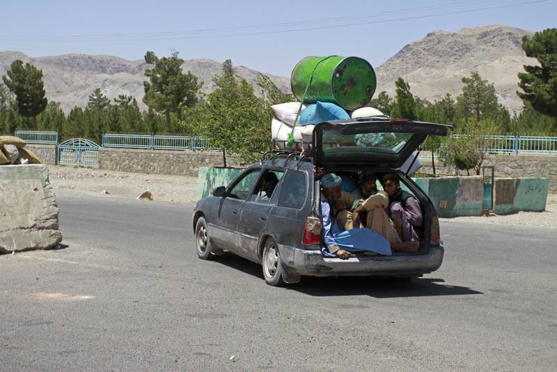 Afghans flee fighting between the Taliban and security forces on the outskirts of Herat, west of Kabul. AP