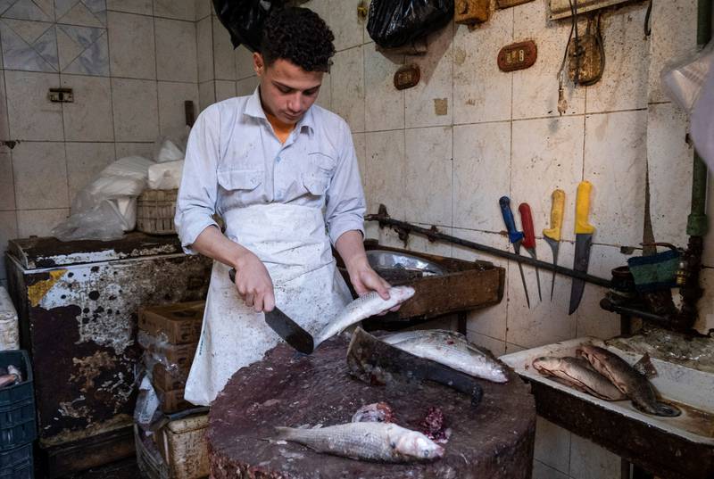 Fish being cleaned for iftar at Sayeda Zainab fish market in Cairo during Ramadan