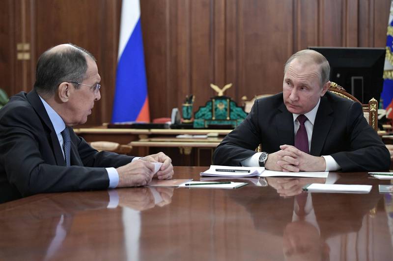 Russia's President Vladimir Putin (R) attends a meeting with Russia's Foreign Minister Sergei Lavrov (L) and Russia's Defence Minister in Moscow on February 2, 2019. President Putin on February 2 said Russia was suspending its participation in a key Cold War-era missile treaty in a mirror response to a US move the day before. Moscow and Washington have long accused the other of violating the Intermediate-Range Nuclear Forces agreement. / AFP / Sputnik / Alexey NIKOLSKY
