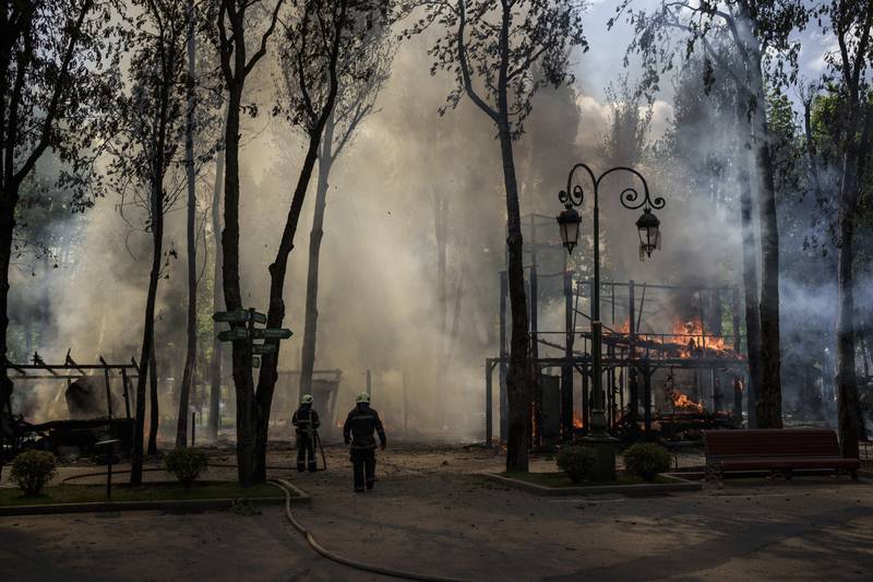 Firefighters work to extinguish flames after a Russian bombardment at a park in Kharkiv, Ukraine. AP Photo