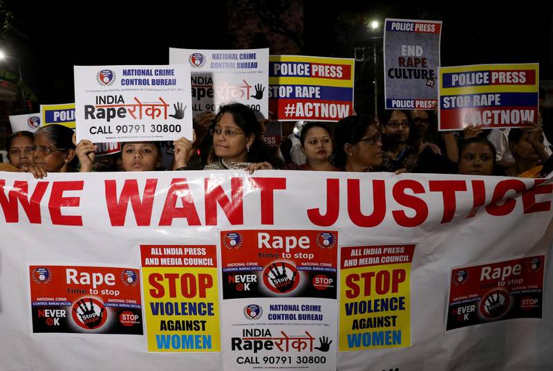 Women display a banner and placards as they attend a protest march against the alleged rape and murder of a 27-year-old woman, in Kolkata, India, December 4, 2019. REUTERS/Rupak De Chowdhuri
