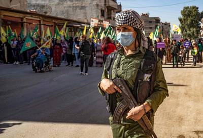 A Syrian Kurdish fighter stands guard during a rally in the northeastern city of Qamishly. AFP
