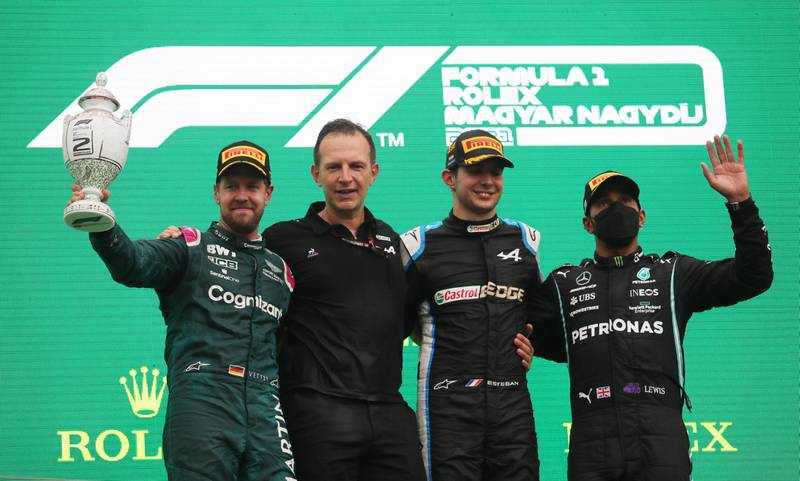 Second placed Sebastian Vettel of Aston Martin, first placed Esteban Ocon of Alpine and third placed Lewis Hamilton of Mercedes on the podium after the race.