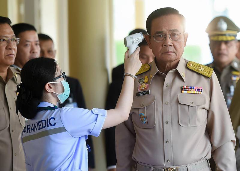 A paramedic checks the temperature of Thai Prime Minister Prayut Chan-o-cha as authorities increase preventive measures against the spread of the coronavirus, at the Government House in Bangkok, Thailand.  EPA