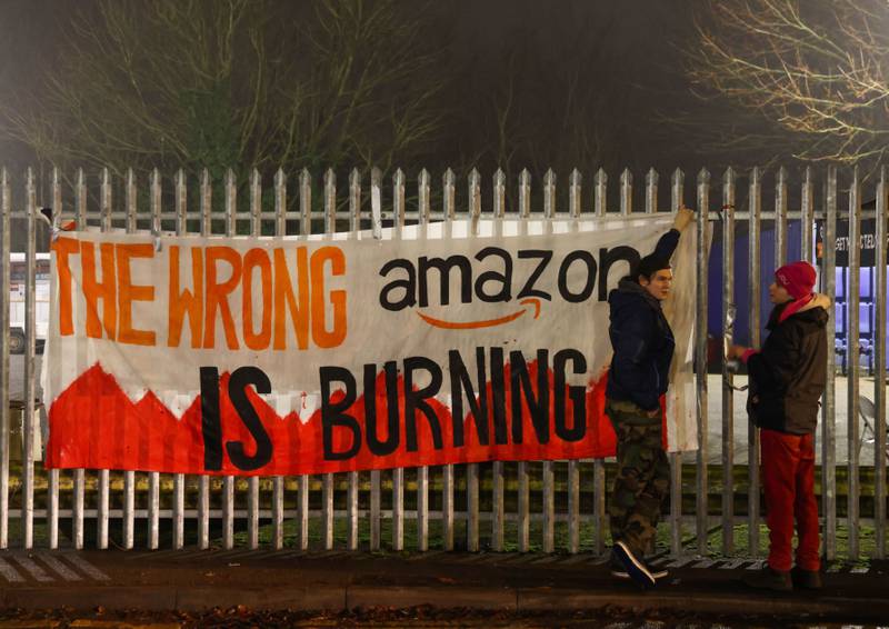 A striking worker's banner reads: 'The wrong Amazon is burning.' Bloomberg