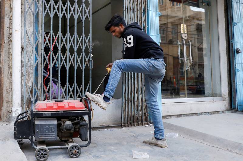 A shopkeeper starts a generator to bring electricity to his store in Karachi. Reuters