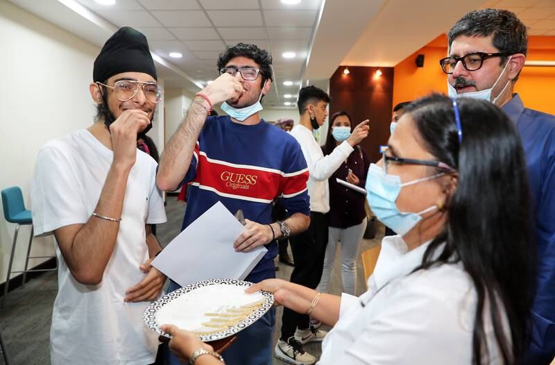 Staff giving sweets to Kabir Singh Pujji, left, and Bhumit Singh, centre, after they received they IB results at Gems Modern Academy at Nad Al Sheba in Dubai. All photos: Pawan Singh / The National