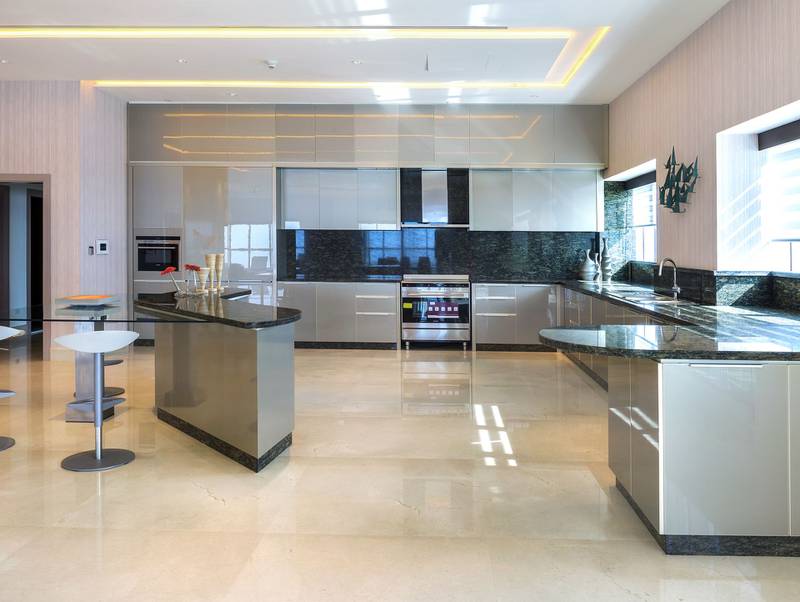 A modern open-plan kitchen with integrated appliances