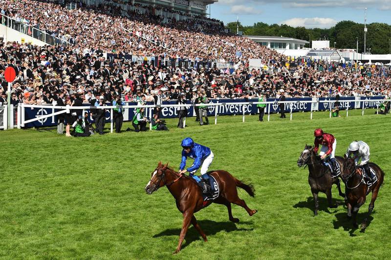 Jockey William Buick crosses the line on Masar for breeder Godolphin, winning the Derby on the second day of the Epsom Derby Festival in Surrey, southern England on June 2, 2018.   / AFP / Glyn KIRK
