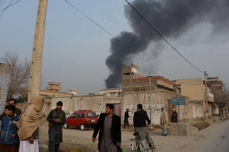 A thick plume of black smoke rises above the compound. Noorullah Shirzada / AFP Photo