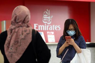 FILE PHOTO: A traveller wears a mask at the Dubai International Airport, after the UAE's Ministry of Health and Community Prevention confirmed the country's first case of coronavirus, in Dubai, United Arab Emirates January 29, 2020. REUTERS/Christopher Pike - RC2JPE94N0K9/File Photo