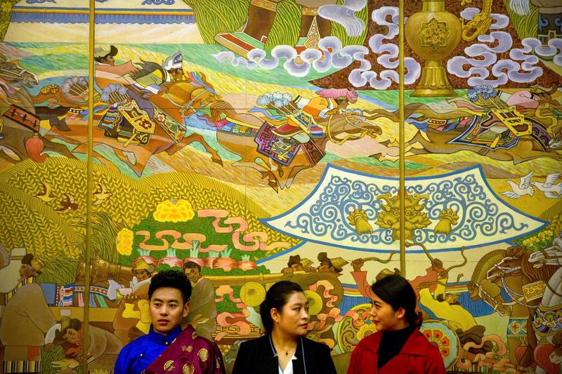 Attendees stand in front of a mural during a group discussion session for delegates from Tibet held on this sidelines of the annual meeting of China's National People's Congress in Beijing. Mark Schiefelbein / AP Photo