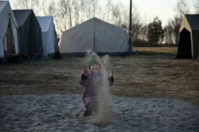 Ukrainian refugee Masha, 6, plays at the border crossing in Budomierz, Poland. Reuters