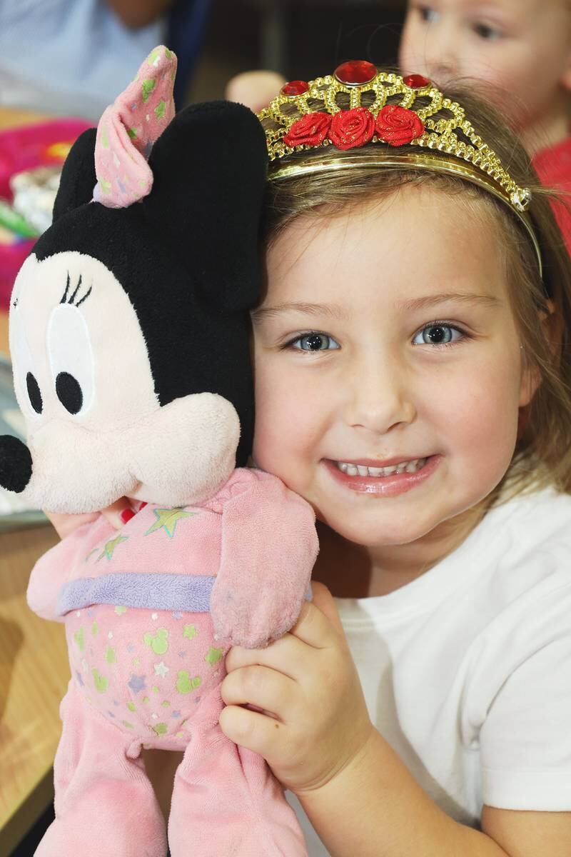 A pupil at the school poses with a Minnie Mouse stuffed toy as she celebrates the queen's platinum jubilee this year. 