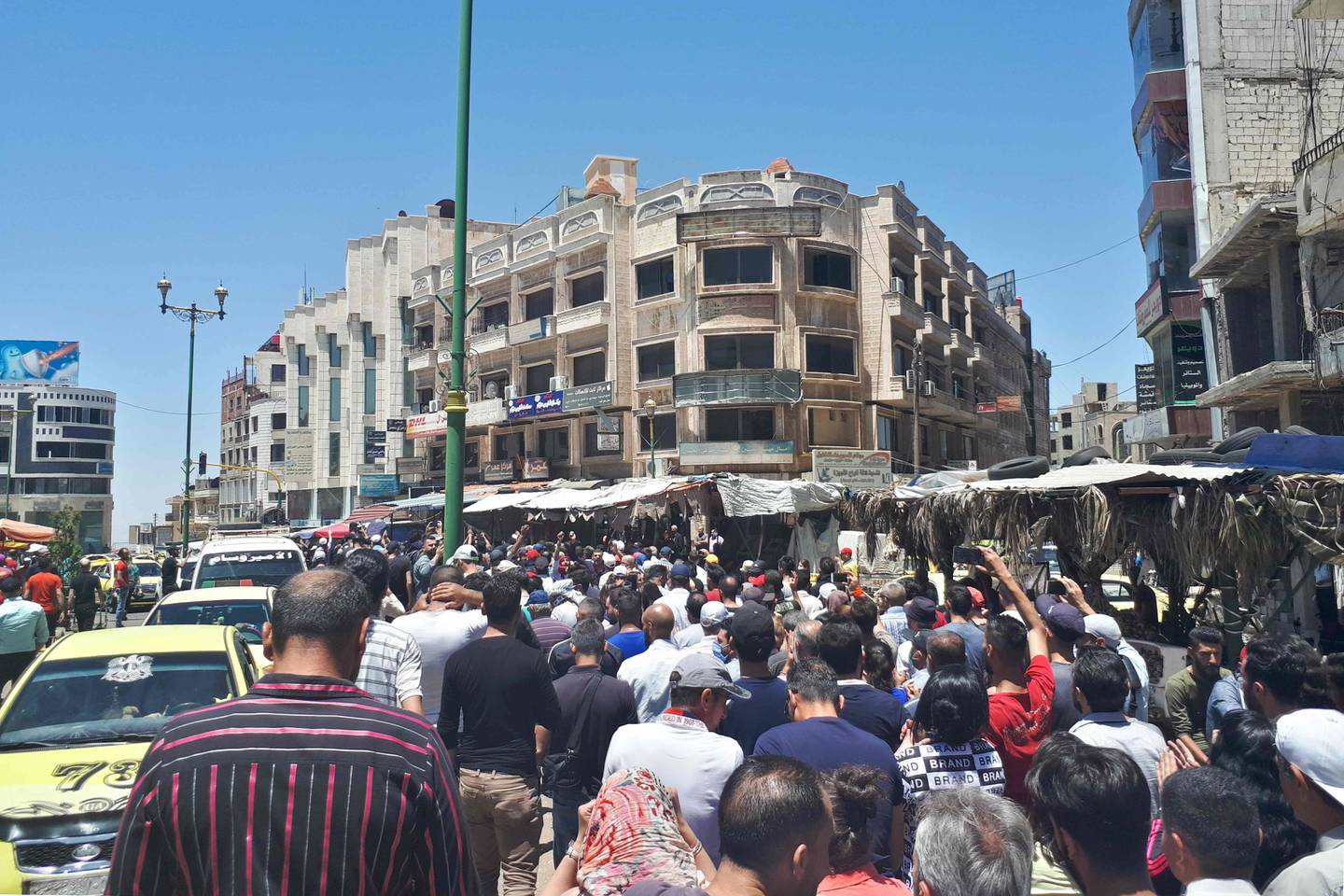 A handout picture released by the local news site Suwayda 24 shows Syrians chanting anti-government slogans as they protest the country's deteriorating economic conditions and corruption, in the southern city of Suwaida on June 9, 2020.  - == RESTRICTED TO EDITORIAL USE - MANDATORY CREDIT "AFP PHOTO / HO / SUWAIDA24" - NO MARKETING NO ADVERTISING CAMPAIGNS - DISTRIBUTED AS A SERVICE TO CLIENTS ==
 / AFP / SUWAYDA24 / - / == RESTRICTED TO EDITORIAL USE - MANDATORY CREDIT "AFP PHOTO / HO / SUWAIDA24" - NO MARKETING NO ADVERTISING CAMPAIGNS - DISTRIBUTED AS A SERVICE TO CLIENTS ==

