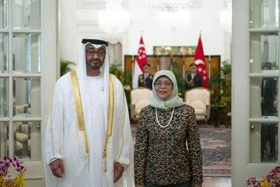 SINGAPORE, SINGAPORE - February 28, 2019: HH Sheikh Mohamed bin Zayed Al Nahyan, Crown Prince of Abu Dhabi and Deputy Supreme Commander of the UAE Armed Forces (L), stands for a photograph with HE Halimah Yacob, President of Singapore, (R), during a reception at the Istana presidential palace.
( Ryan Carter / Ministry of Presidential Affairs )