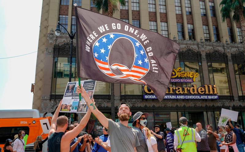 QAnon demonstrators protest child trafficking on Hollywood Boulevard in Los Angeles, California, August 22, 2020. The QAnon movement believes that US President Donald Trump is threatened by a "deep state" within the US government and that American elites are devil-worshipers who conspire to traffic children. AFP