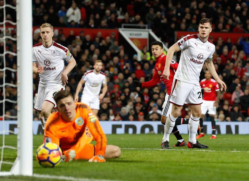 Manchester United's Jesse Lingard, center, scores his side's first goal of the game during their English Premier League soccer match against Burnley at Old Trafford, Manchester, England, Tuesday, Dec. 26, 2017. (Martin Rickett/PA via AP)