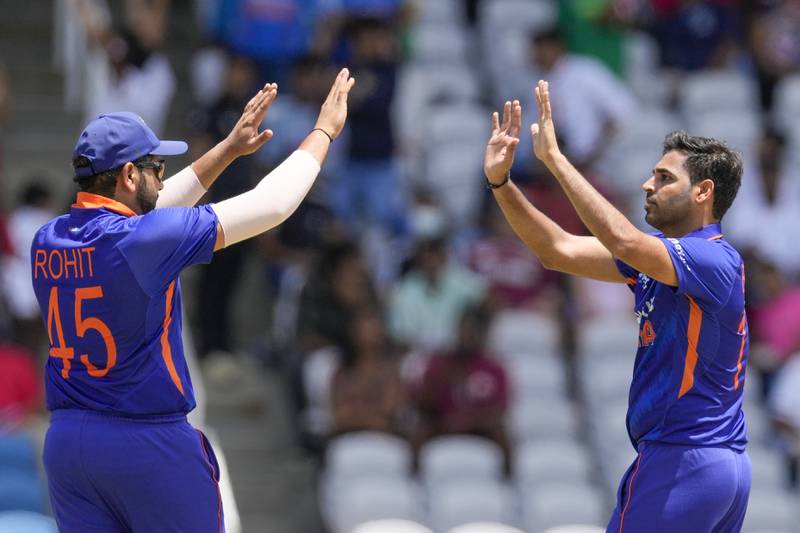 India's Bhuvneshwa Kumar, right, celebrates with captain Rohit Sharma the dismissal of Shamarh Brooks. AP
