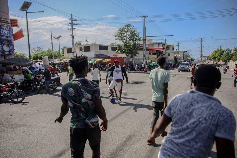 People play football on the street during the general strike in Port-au-Prince. AFP
