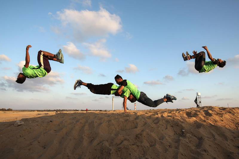 Palestinian youths practice their parkour skills at the Israel-Gaza border in the southern Gaza Strip. Said Khatib / AFP