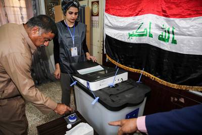 An Iraqi voter dips his finger in ink before casting his ballot at a poll station in the capital Baghdad's Karrada district. Sabah Arar / AFP