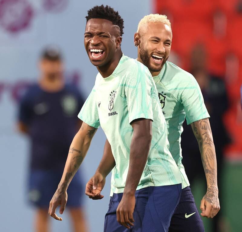 Neymar jokes with teammate Vinicius Junior during a training session at Al Arabi SC Stadium on December 8, 2022. Getty