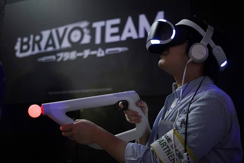 A visitor tries out a PlayStation VR headgear device at the Tokyo Game Show in Chiba. Eugene Hoshiko / AP Photo