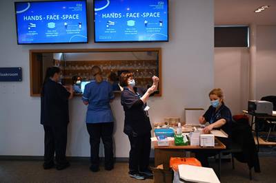 Healthcare professionals prepare doses of the vaccine at Chester Racecourse. Boris Johnson called Britain hitting a target of inoculating 15 million of the most vulnerable people with a first coronavirus jab "a significant milestone". AFP