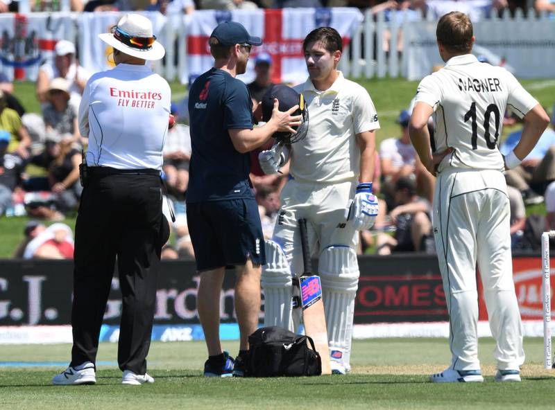 England's Rory Burns is checked by medical staff after being struck on the helmet. Reuters