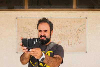 Hassan Kiyany filing his documentary about an abandoned school. Courtesy Ammar Al Attar