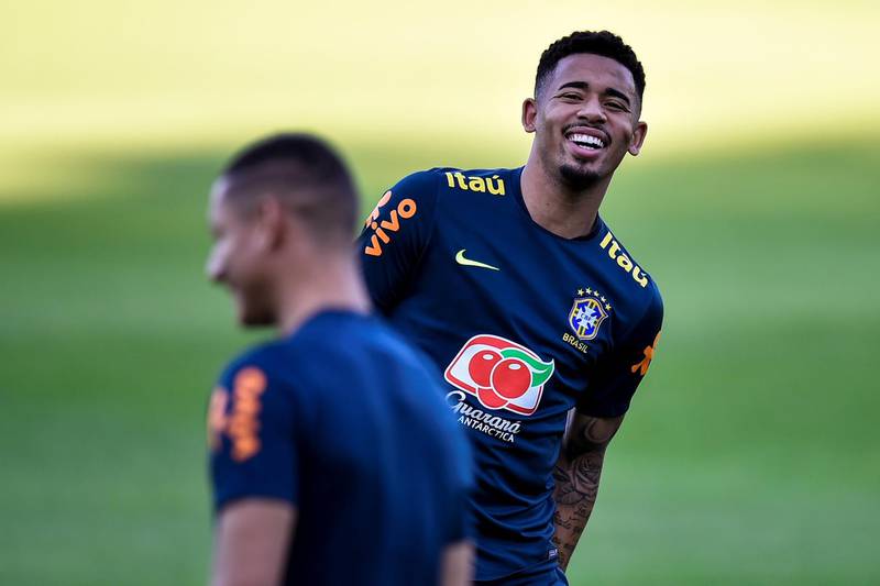 Gabriel Jesus shares a joke with a teammate during training with Brazil. EPA
