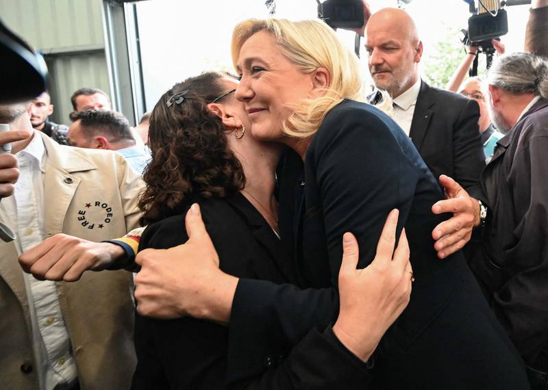 Marine Le Pen embraces a supporter as she arrives to deliver a speech at Henin-Beaumont in the Pas De Calais on Monday. AFP
