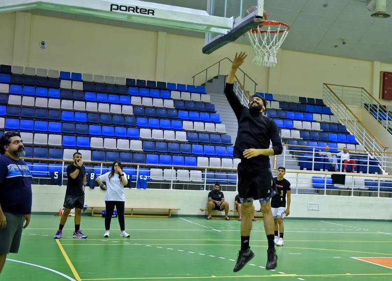 Reyadh, centre, oversees a training session in Manama.