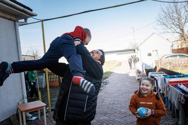Bloom plays with Yurii, 6, in Demydiv, Ukraine. Reuters