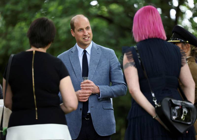 Britain's Prince William speaks with guests as he hosts a garden party at Buckingham Palace to celebrate the 73rd anniversary of the National Health Service.