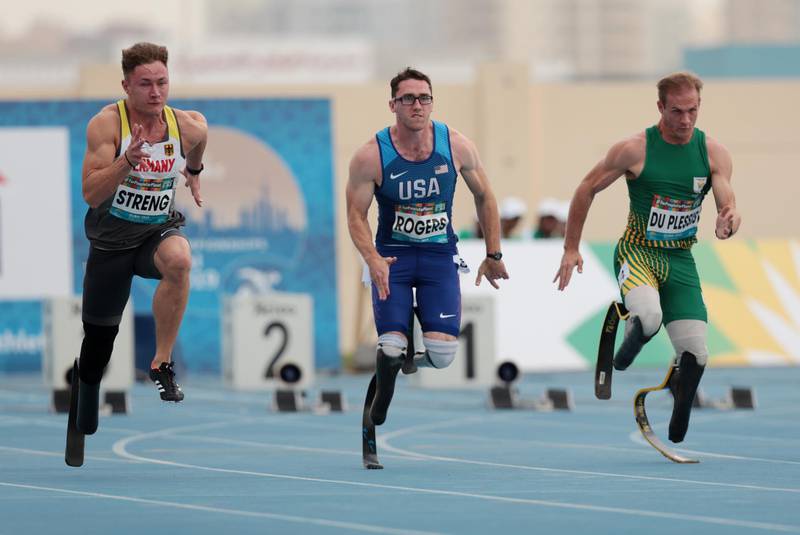 Germany's Felix Streng, Nick Rogers of the U.S. and South Africa's Danield Du Plessis during the men's 100m T64 heat in Dubai. Reuters