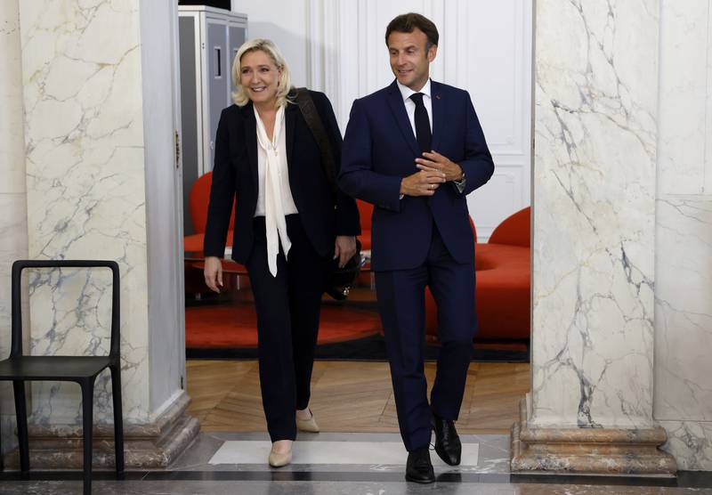 French President Emmanuel Macron, right, meets National Rally leader Marine Le Pen at the Elysee Palace in Paris in June. AP Photo