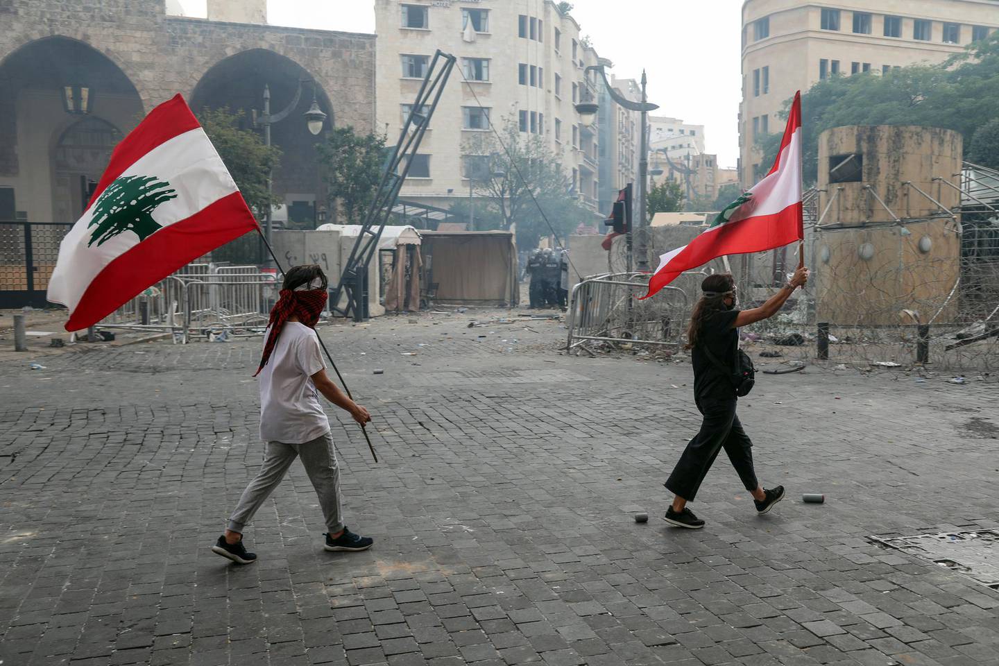 Protesters wave Lebanese national flags during a demonstration close to parliament in Beirut, Lebanon, on Saturday, Aug. 8, 2020. Lebanese protesters took to the streets of Beirut on Saturday amid growing anger at the government following the devastating blast that killed dozens this week. Photographer: Hasan Shaaban/Bloomberg