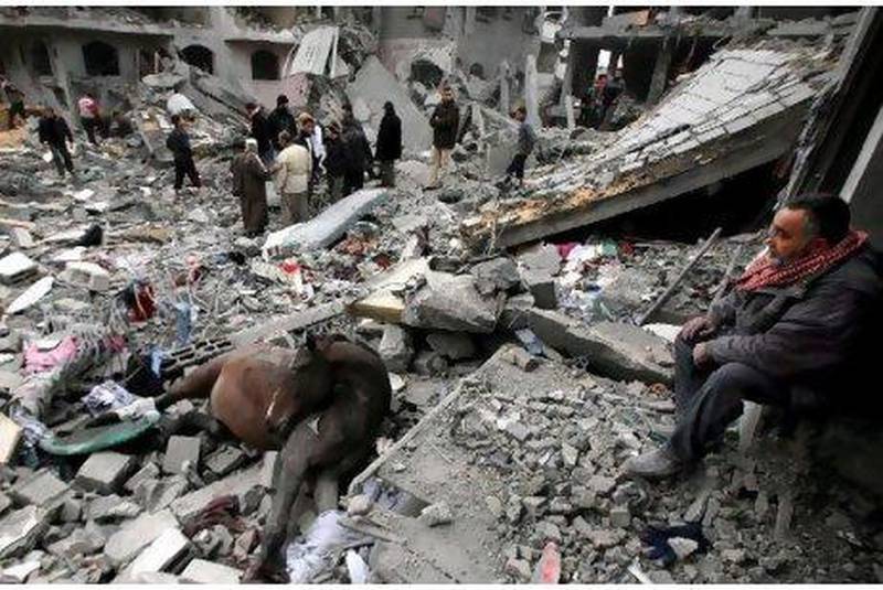 A dead horse lays in the rubble as Palestinians inspect homes destroyed by Israeli missiles strikes in 2009. Recent leaked documents show that the Palestinian Authority agreed to delay a UN vote that would have condemned Israel for its invasion of the Gaza Strip.