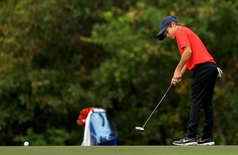 Charlie Woods putts on the 15th hole during the final round of the PNC Championship at the Ritz Carlton Golf Club. AFP