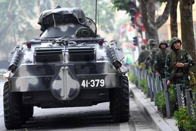 Vietnamese soldiers stand next to an armoured personnel carrier during the summit. AFP