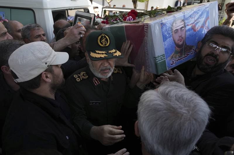 Chief of Iran's Revolutionary Guard Hossein Salami carries the flag-draped coffin of Milad Heidari, a Guard member who was killed by an Israel airstrike in Syria on Friday, during his funeral procession in Tehran, Iran, Tuesday, April 4, 2023.  (AP Photo / Vahid Salemi)