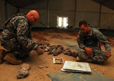 Geospatial engineers in the New York Army National Guard's 27th Infantry Brigade Combat Team build a sand table to prepare for the headquarters' combined arms rehearsal in Fort Irwin, California, in October 2011. Photo: US Army