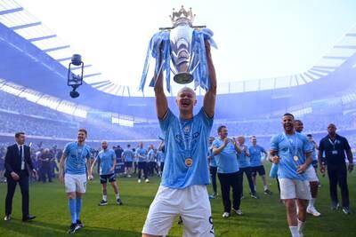 City striker Erling Haaland celebrates with the trophy. Getty