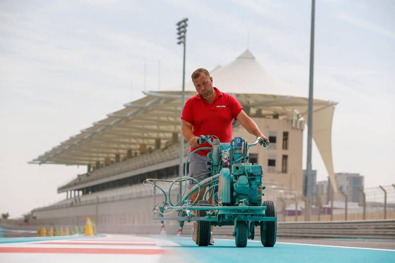 A painter lays down a fresh coat of Yas Blue on the circuit. Courtesy Yas Marina Circuit