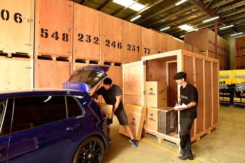A customer moves his personal belongings to a storage pod at Easytruck Moving & Storage. Furniture is the top storage item, while seasonal possessions such as ski gear and festive decorations are also common. Photo: Easytruck Moving & Storage