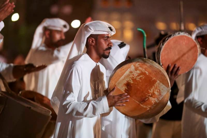 Emirati men drumming traditional folklore.